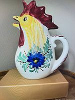 Front view of hand-painted rooster pitcher