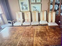 Six high-back chairs shown at dining table to display style and overall look (one chair at far left partially visible)