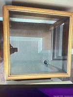 Top view showing square shape, glass insert and wood frame