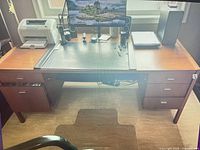 Front view of desk showing leather insert and both drawer pedestals