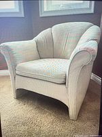 Front view of armchair showing color, design and cushion