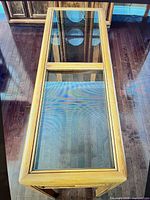 Top view of console table showing glass insert panels and wood frame