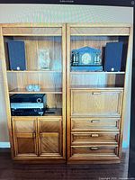 Front view of both oak units showing shelves, cabinets and drawers