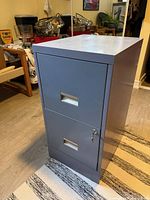 front and right side view showing two drawers, recessed handles, key in lock