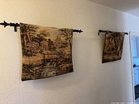 Both tapestries on wall showing size and hanging rods