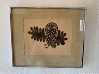 Full view of framed Lucy Qinnuayuak print on wall