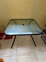 Full view of square glass top patio table