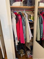 Closet view showing assortment of women’s jackets and coats on hangers