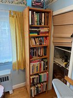 Front view of tall pine bookshelf with six shelves