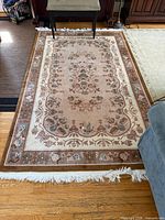 Full view of wool rug showing overall design and fringe