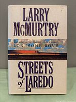 Front view of hardcover book with dust jacket showing title and author