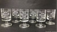 Six etched Fürst Bismarck shot glasses arranged in two rows showing logo detail and overall condition