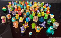 Top view of approximately 80 multicolored mini figures arranged on surface