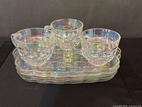 Three cups stacked on three snack plates showing overall set