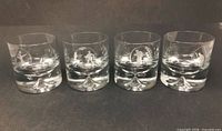 Front view of all four etched rocks glasses