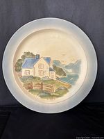 Front view of ceramic plate with cottage scene