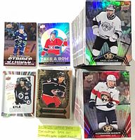 Assortment of insert cards (Strides, Take A Bow, Pure Gold) and two tall stacks of base cards