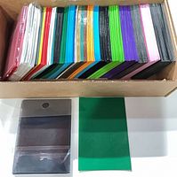 open box showing multiple stacks of colored sleeves and separate sample pieces