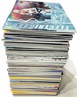 Tall stack of assorted hockey trading cards showing quantity and card edges