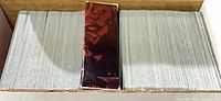 Open cardboard holder showing two large stacks of Young Jedi cards and a red Darth Maul starter deck box
