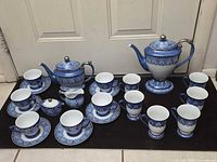 Entire 22-piece set arranged, showing both pots, creamer, covered sugar, cups and saucers
