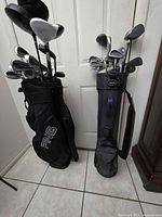 Two golf bags filled with clubs