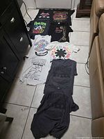 Nine shirts laid out on floor in two columns