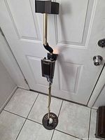 Full view of Tesoro Toltec 2 metal detector standing upright