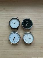 Front view of four watch heads showing dial colors and cases