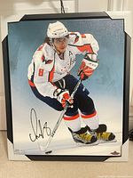 Front view of framed, signed canvas print