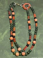 Full view of double strand beaded necklace laid flat