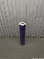 Full view of purple vinyl roll standing upright with cardboard core visible