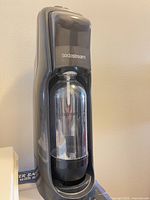Front view of Sodastream unit with bottle inserted
