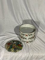 Three tiers stacked with lid beside showing interior and painted motifs