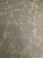 Full view of both broken bead chains laid flat