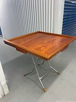 Overhead view of square wooden mahjong table on metal folding legs