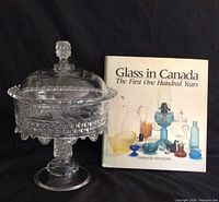 Compote assembled with lid beside reference book front cover