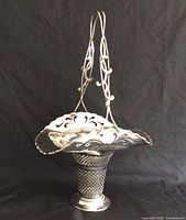 Full view of silver-plate basket with handle upright