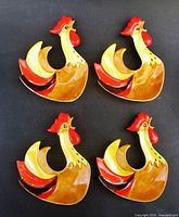Front view of four rooster dishes showing glaze colors