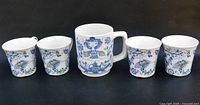 Front view of mug and four cups showing Lotte pattern
