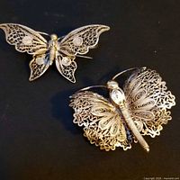 Front view of both sterling filigree butterfly brooches