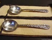 Top view of both sterling spoons showing floral handles and bowls