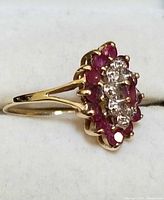 Side view of 10K gold ring showing profile of ruby and diamond cluster