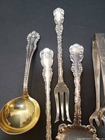 Group view of all five sterling utensils