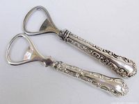 Both sterling handled bottle openers, top view