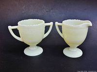 Front view of creamer and sugar on pedestal bases