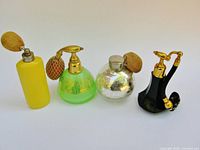Group shot of four atomizer bottles in a row