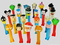All 23 Pez dispensers front view showing character heads and stem colours