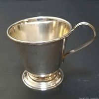 Full view of sterling silver baby cup showing shape and handle