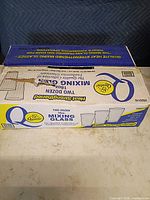 Closed Qualité box showing product branding and two-dozen capacity